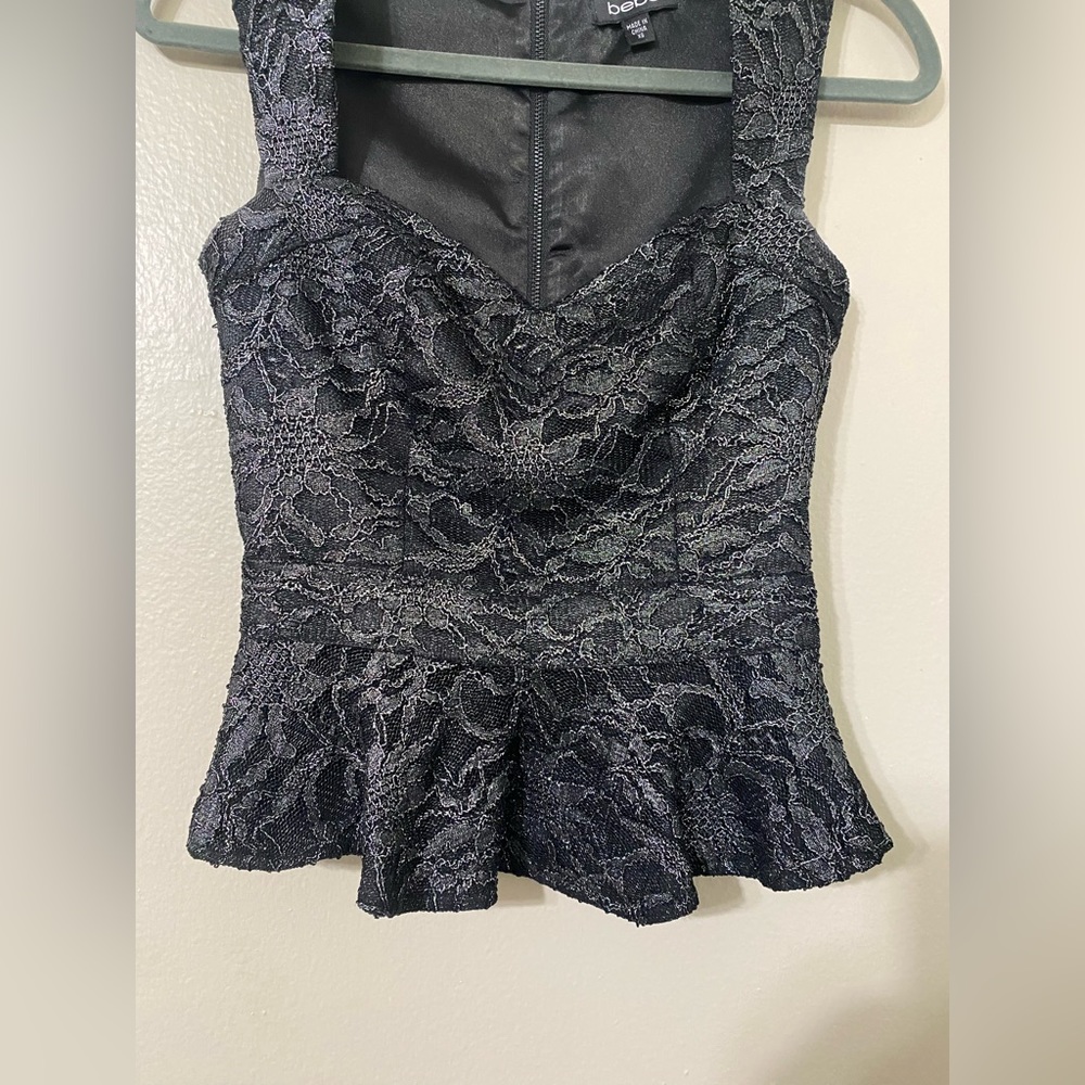 Black express body  shaped top size XS with a bit of silver coloring to it